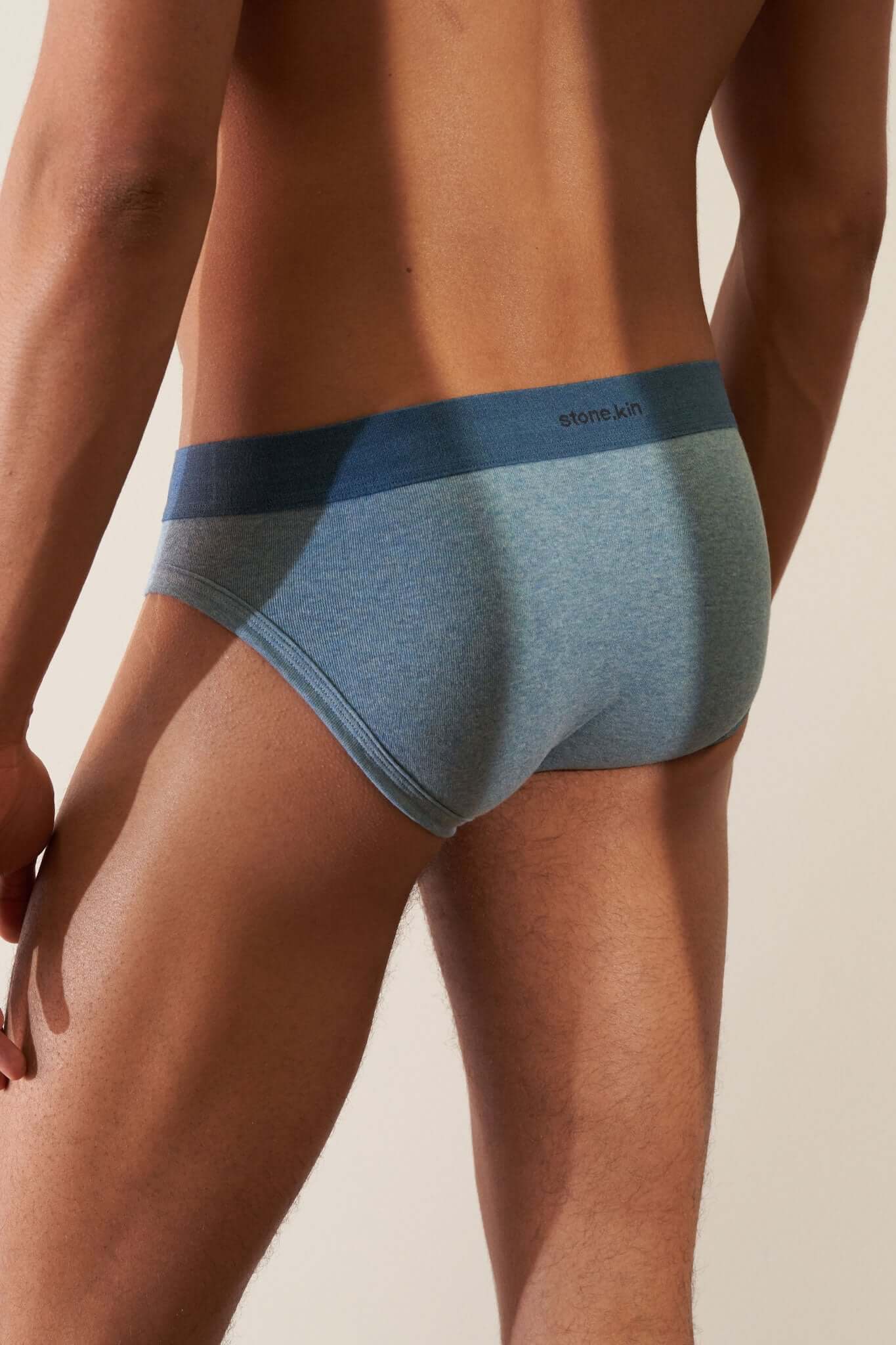 Men's Brief 3 Pack in Organic Cotton - model showcasing blue split brief from behind, emphasizing comfort and style.