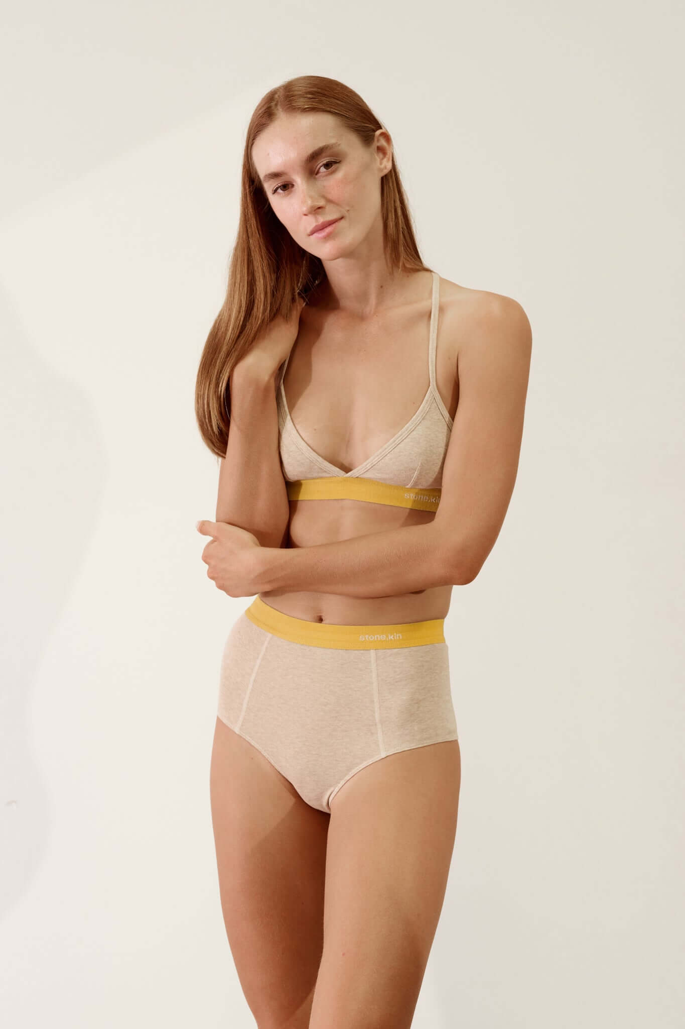 Hi Brief in Organic Cotton Rib - Sand and Mustard model showcasing high-waisted silhouette and soft organic fabric.