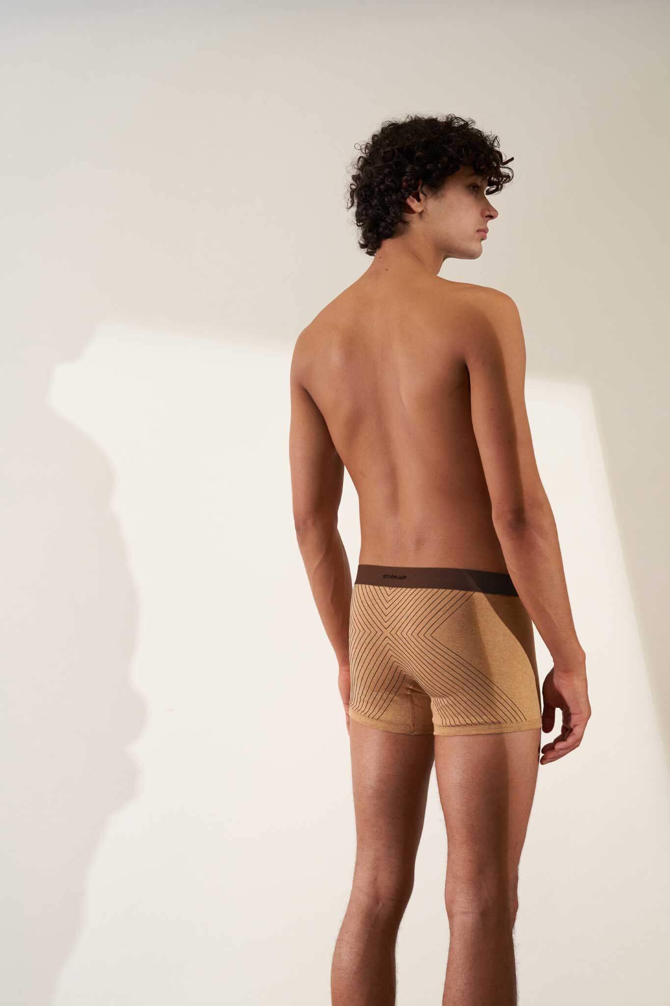 Boxer brief in organic cotton rib, camel color with brown cross, showcasing comfort and non-toxic GOTS certified fabric.