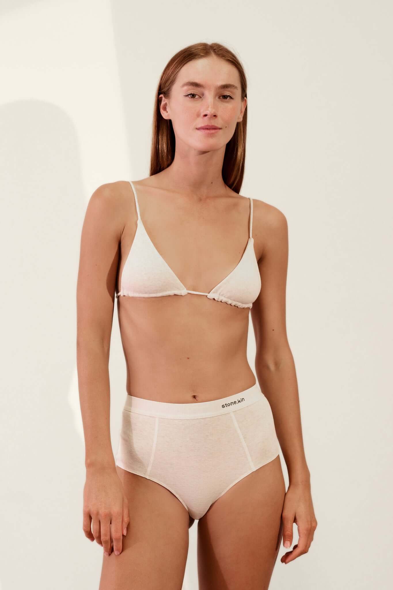 Model wearing Triangle Bralette in Organic Cotton Rib - Bone with matching high-waisted underwear, showcasing comfort and style.