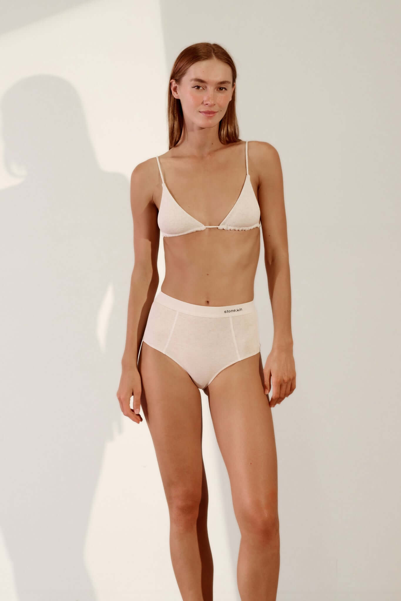 Hi Brief in Organic Cotton Rib - Bone worn by a model, showcasing the high-waisted silhouette and natural fabric.