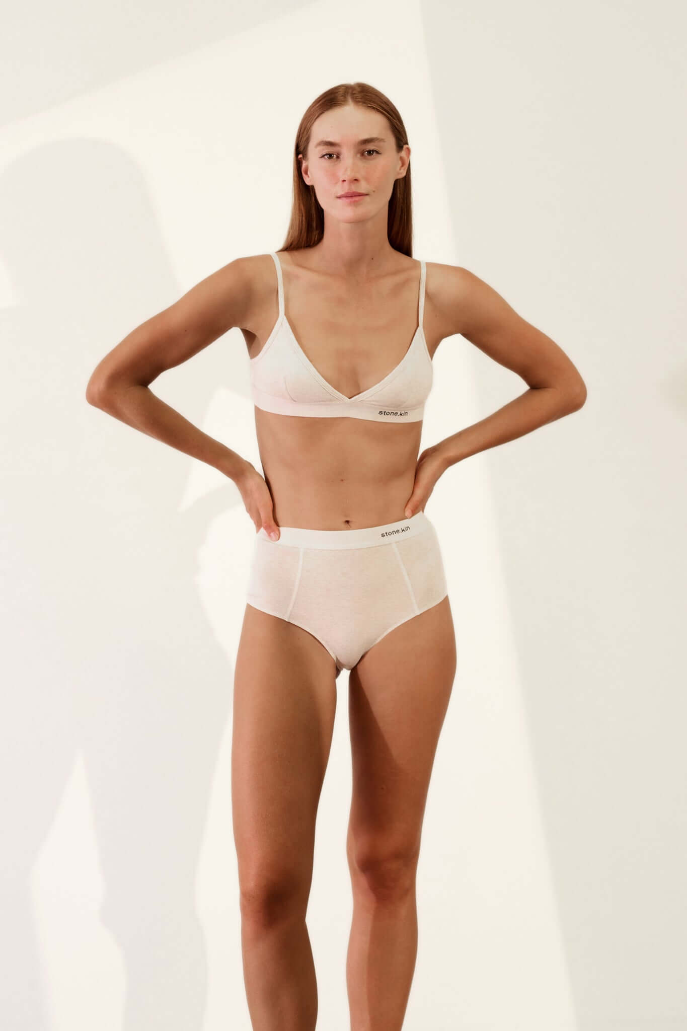 Model wearing Hi Brief in Organic Cotton Rib - Bone with matching top, showcasing the softness and high-waisted style.