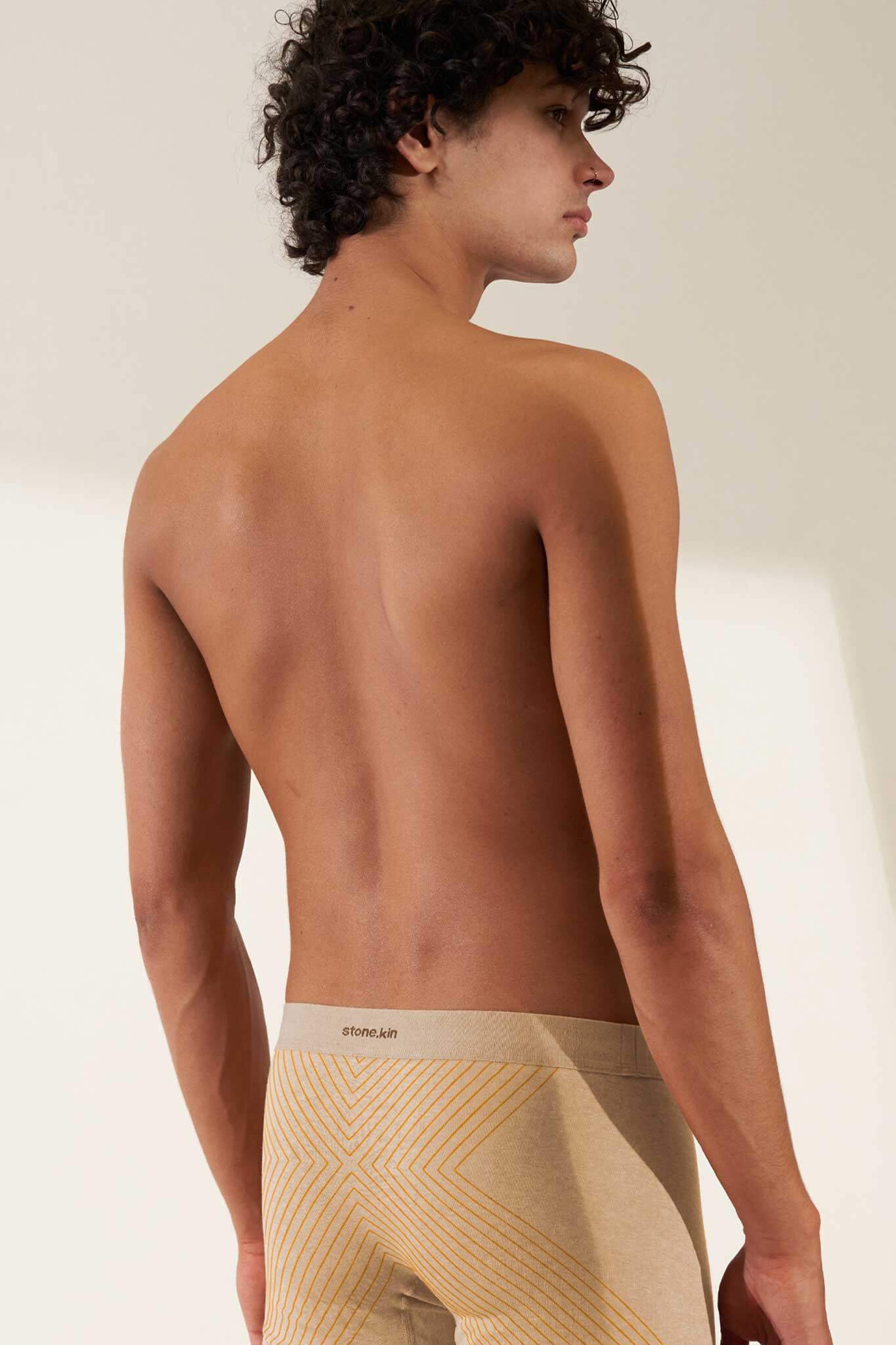Boxer brief in organic cotton rib, sand melange color with orange cross, showcasing comfort and GOTS certified non-toxic fabric.