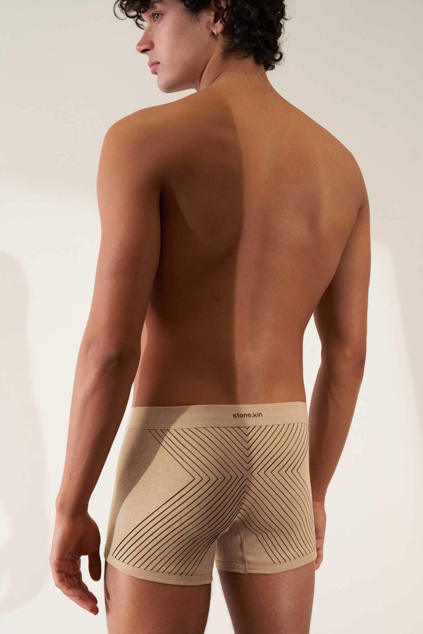 Men's organic cotton boxer brief in sand melange rib with tar cross design, offering comfort and GOTS certified non-toxic fabric.