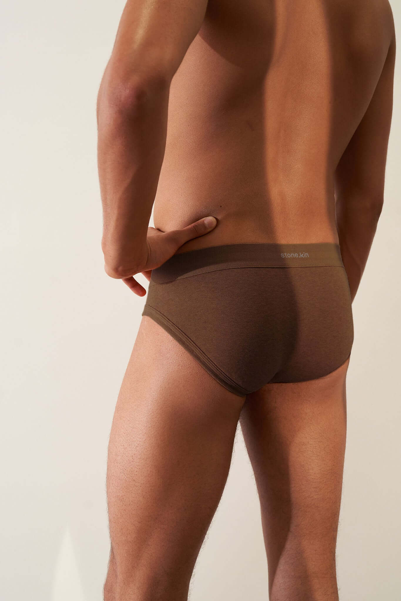 Men's Brief 3 Pack in Organic Cotton - brown brief model worn from behind, showcasing comfort and fit.