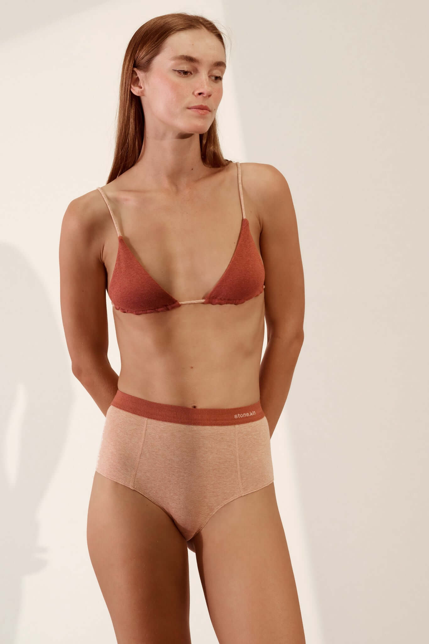 Triangle Bralette in Organic Cotton Rib - Rust / Nude worn by model with matching high-waisted underwear.