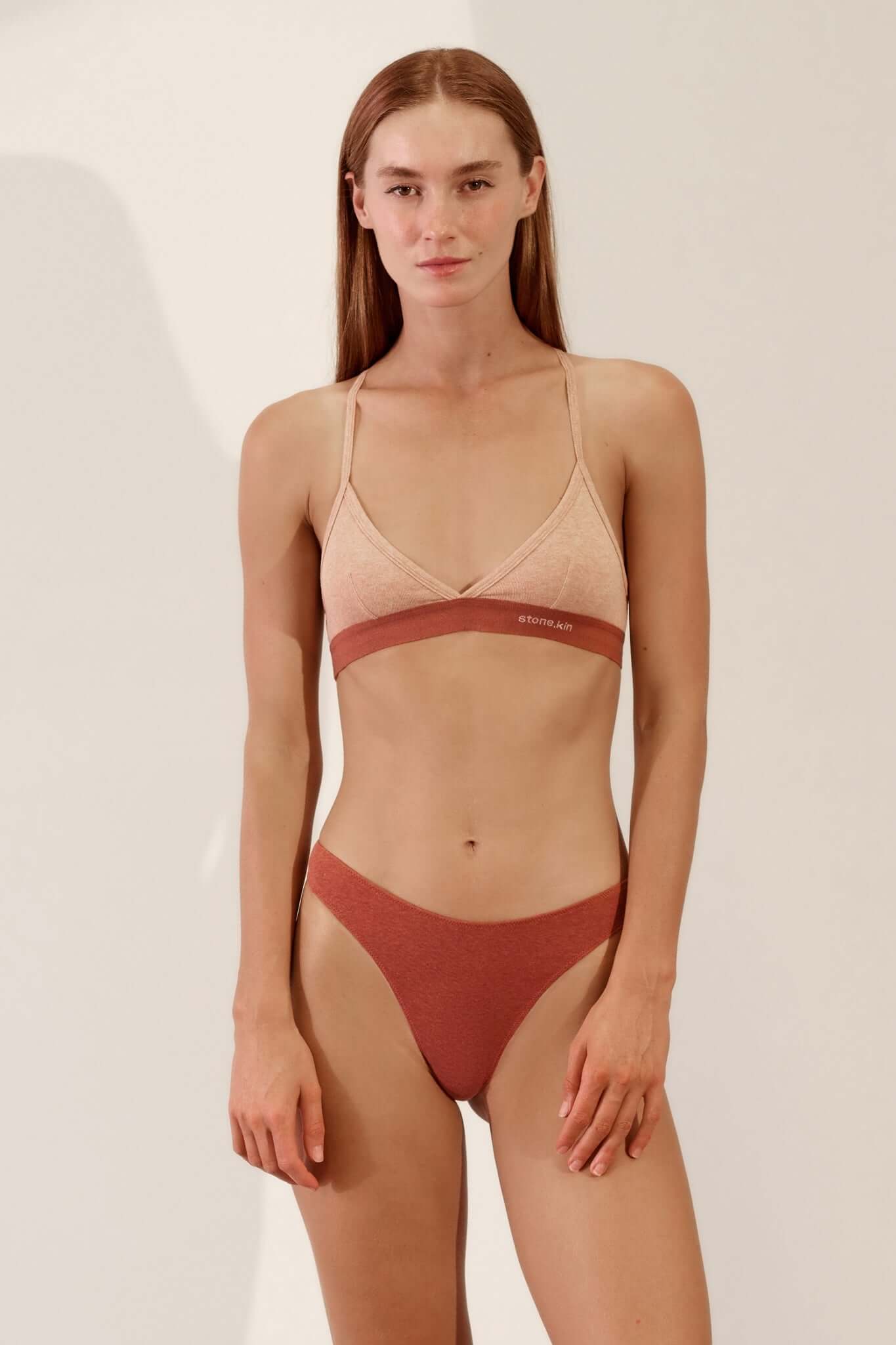 Model wearing Hi Thong in Organic Cotton Rib - Rust, showcasing comfort and style.